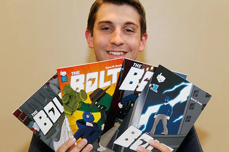 Ryan Brady, 25, shows his "Bolt" comic books. ( AKIRA SUWA  /  Staff Photographer )