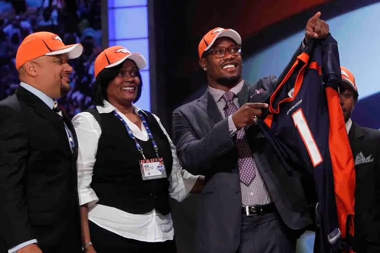 Texas A&M linebacker Von Miller gestures alongside family members after he was selected as the second pick by the Broncos.