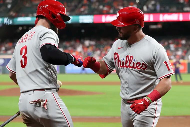 The Phillies roster has largely been constructed through free-agent signings, including big-ticket contracts like Kyle Schwarber (right) and Bryce Harper.