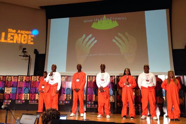 Students from John Bartram High School present their solutions to the “school-to-prison pipeline” while wearing prison jumpsuits at the Aspen Challenge on April 11, 2018.
