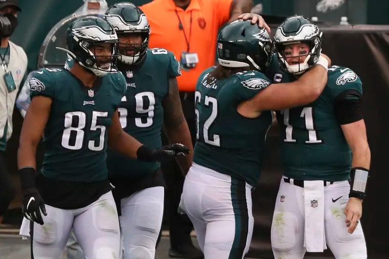 Eagles QB Carson Wentz celebrates Jason Kelce after scoring a touchdown in the fourth quarter. The game ended in an overtime draw, 23-23.