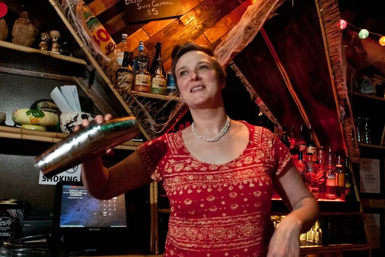Phoebe Esmon shakes a drink behind the tiki bar at the Yachtsman in Fishtown.