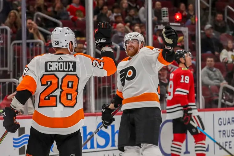 Claude Giroux (28) celebrates with Jake Voracek (93) after Giroux scored his first goal of the season during the second period of the Flyers' 4-1 win over Chicago Thursday night.