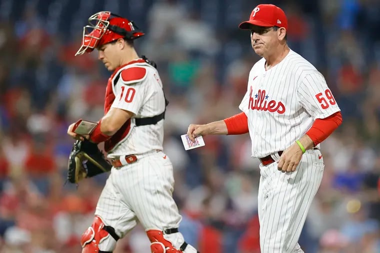 Phillies interim manager Rob Thomson and catcher J.T. Realmuto after a pitching change against the Washington Nationals on Saturday.