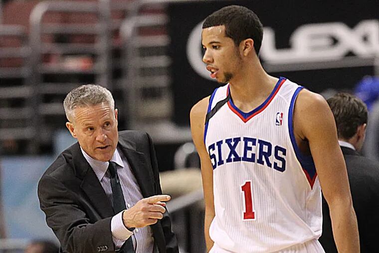Sixers head coach Brett Brown and point guard Michael Carter-Williams. (Yong Kim/Staff Photographer)
