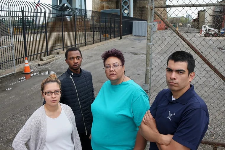 From left, North Camden residents Felisha Reyes Morton, Rudy M. Underdue, Jackie Santiago and Luis Gaitan stand for a portrait outside the F.W. Winter building in Camden on Friday, April 27, 2018. They oppose the proposed erection of a 16-story digital billboard on the site by Interstate Outdoor Advertising CEO Drew Katz.