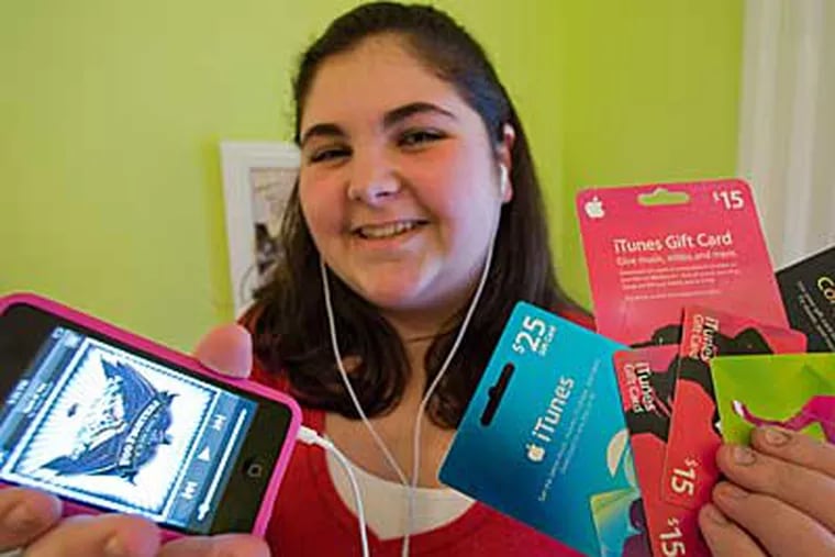 Meg Girton likes iTunes cards for convenience: "You can just jump on the computer, browse, shop, pick up . . . tunes and create a playlist - and that's all before the bus comes." (DAVID M WARREN / Staff Photographer)
