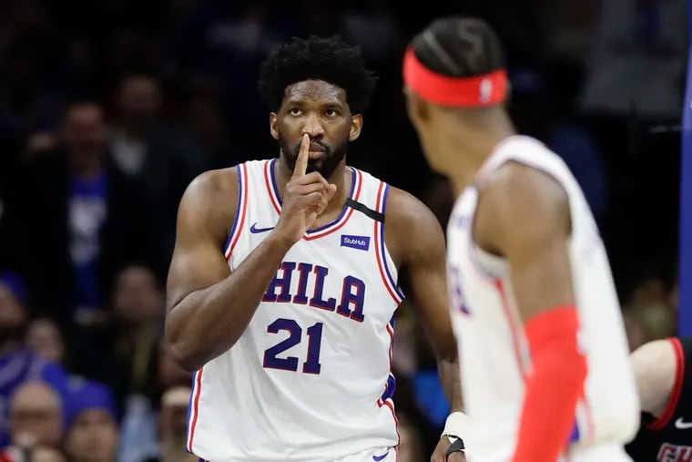 Sixers center Joel Embiid raises his finger to his mouth during the win against the Chicago Bulls on Sunday.