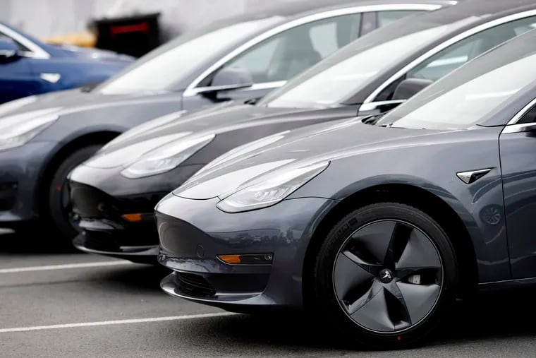 A line of unsold 2019 Model 3 sedans sits at a Tesla dealership in Littleton, Colo. (AP Photo/David Zalubowski, File)