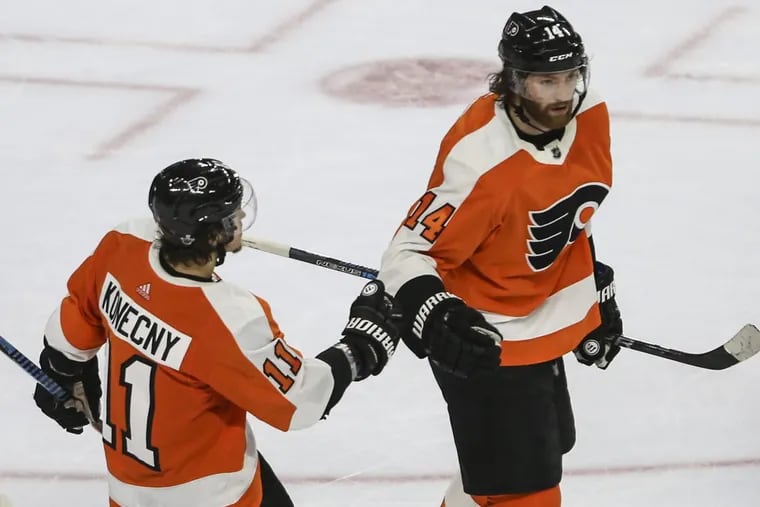 Sean Couturier (right) is congratulated by Travis Konecny after he scored a hat trick in Sunday’s 8-5 loss to Pittsburgh, which won the series, four games to two.