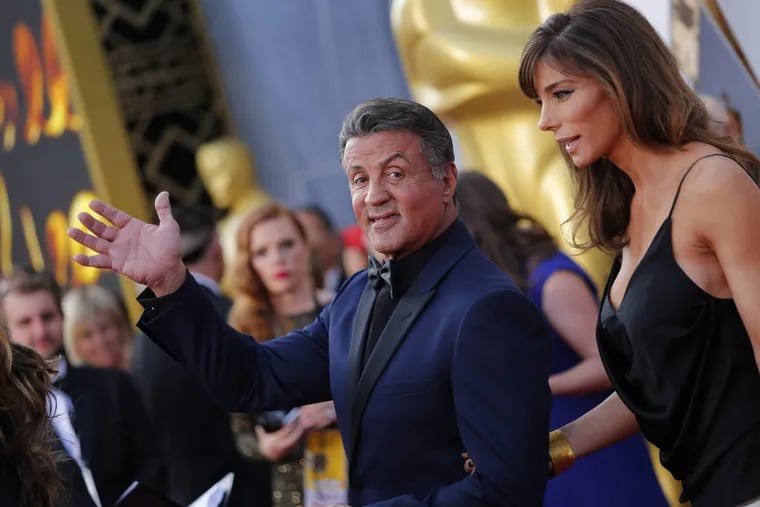 Sylvester Stallone and wife Jennifer Flavin arrive at the 88th Academy Awards on February 28, 2016, at the Dolby Theatre in Hollywood. ()