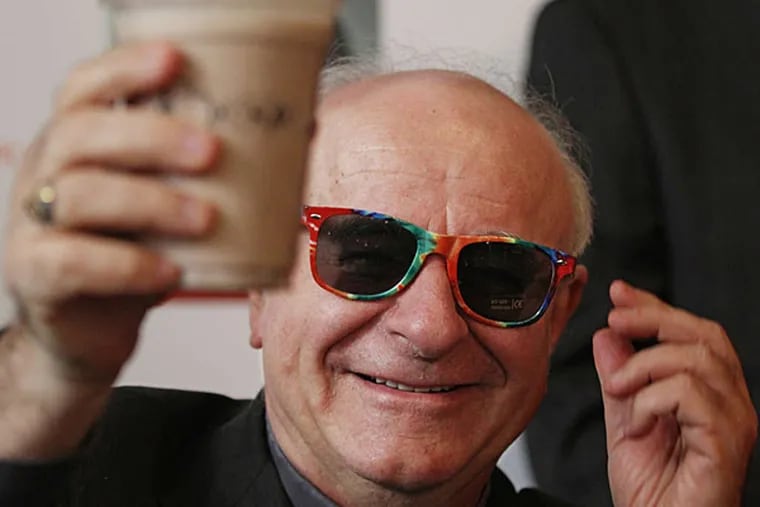 March 2015: Archbishop Vincenzo Paglia, in rainbow sunglasses, holds up the official papal milkshake at Potbelly Sandwich Shop.