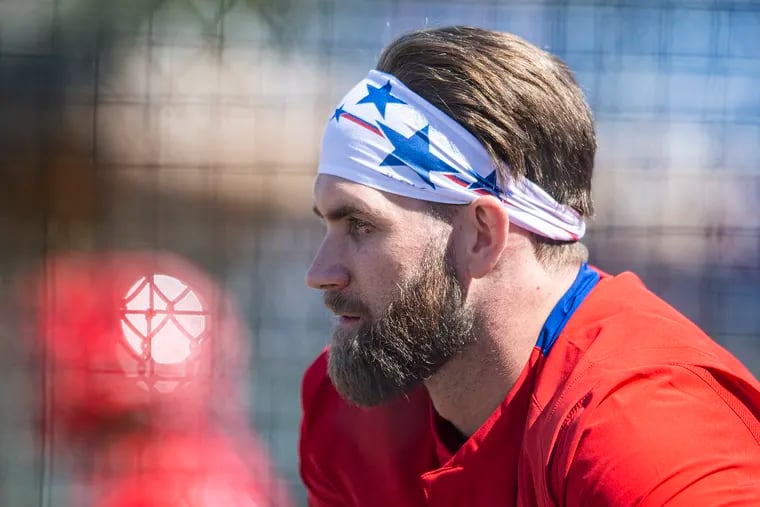 Phillies star Bryce Harper looks on during a spring-training workout Thursday in Clearwater, Fla.