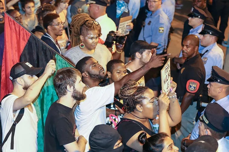 Philly Coalition for REAL Justice protesters confront police outside the 24th and 25th District headquarters. A multiracial crowd marched Saturday night in what they said was an effort to &quot;disrupt&quot; and &quot;shut down&quot; police activity and area traffic.