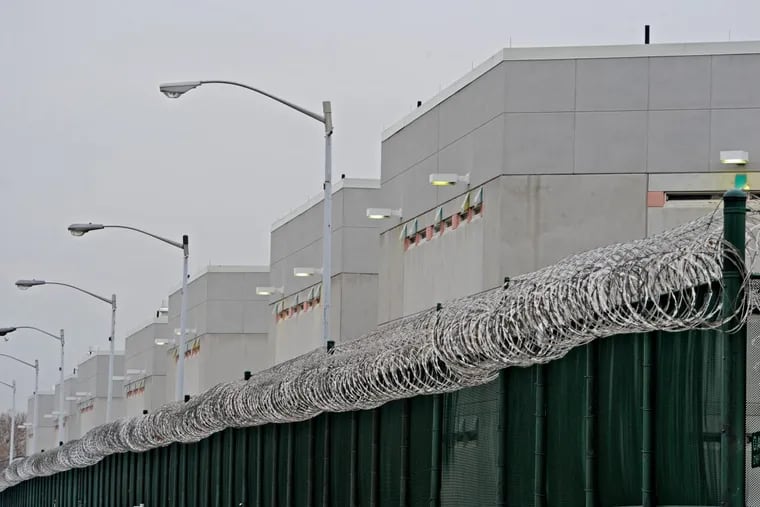 Behind the fence and the razor coil wire on top is the Curran-Fromhold Correctional Facility on State Road in Philadelphia.
