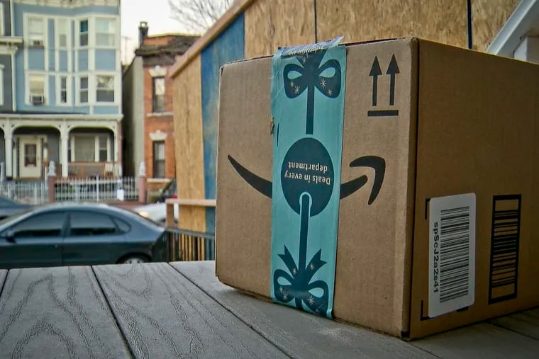 This image taken from video shows an Amazon package containing a GPS tracker on the porch of a Jersey City, N.J. residence after its delivery Tuesday, Dec. 11, 2018. The explosion in online shopping has led to porch pirates and stoop surfers swiping holiday packages from unsuspecting residents. The cops in one New Jersey city are trying to catch the thieves with some trickery of their own.