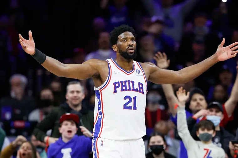 Sixers center Joel Embiid raises his arms after making a lay-up and getting fouled in the fourth quarter against the Cleveland Cavaliers on Saturday, February 12, 2022 in Philadelphia.