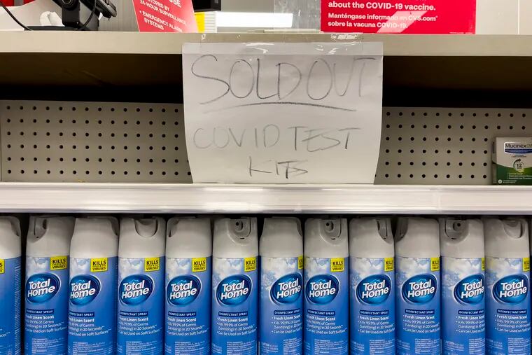 A handwritten notice was posted on an empty shelf after at-home COVID-19 test kits were sold out at a CVS store in La Habra, Calif.