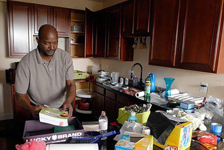 Malick Kande packs up his belongings from the poorly-built condominiums in Norristown. (Ron Tarver / Staff Photographer)