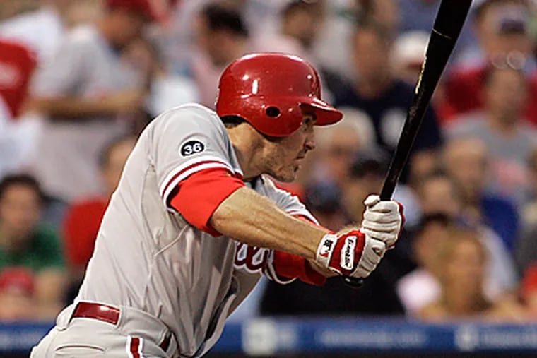 Chase Utley hits a two-run single during the fifth inning of the Phillies' 9-0 win over the Blue Jays. (AP Photo/Tom Mihalek)