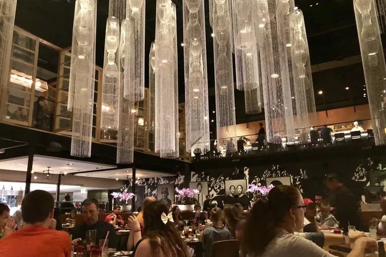 Chandeliers shaped like jellyfish hang above the dramatic dining room at Morimoto Asia in Disney Springs. 