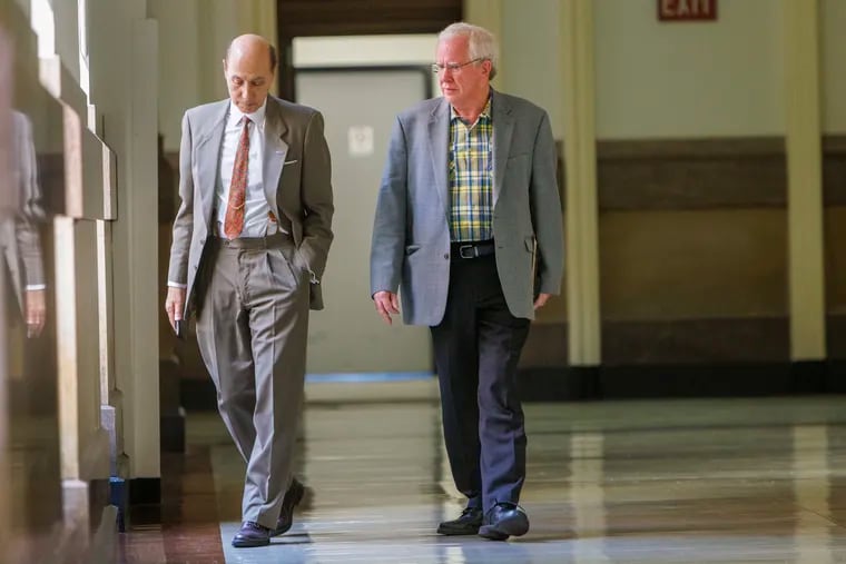 Attorney and Republican ward leader Matthew Wolfe (left) walks alongside Vince Fenerty, chair of the Philadelphia Republican Party, in City Hall in August. Both are leaders of the city GOP, which is facing an existential test this November.