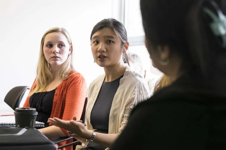 Allison Sparrow (left) listens as Elese Lau discusses strategies to combat anti-scientific beliefs with University of Pennsylvania education professor Susan Yoon (right).