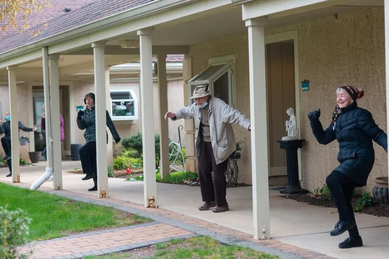 (From right) Diane Nolan, Paul Felton, and Claudette Kuczmanski do some aerobic exercises in the courtyard at Meadowood, a senior living facility in Worcester. Because of social distancing, regular classes had to be canceled.