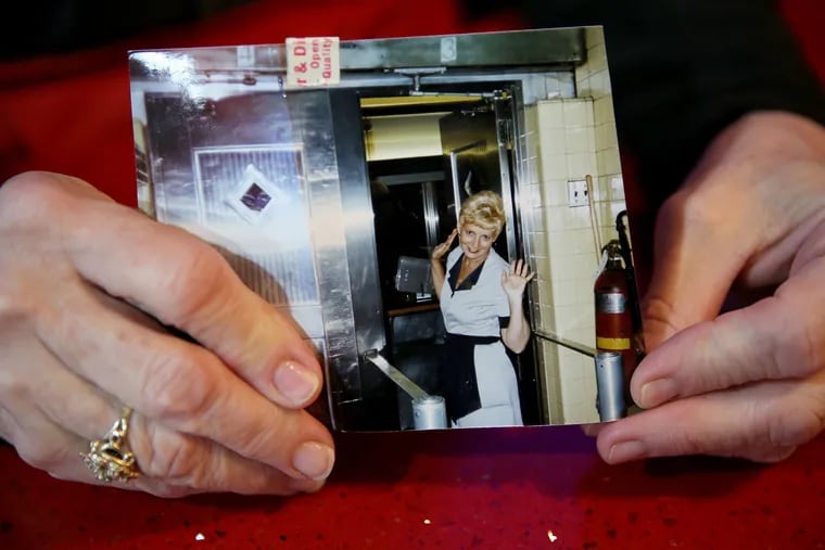 Linda Harris shows a photograph of herself when she first started working at the Mayfair Diner in Northeast Philadelphia more than 20 years ago. The diner is one of a handful of 24-hour diners remaining in the city.