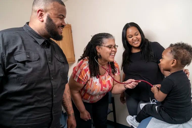 Shawn Jackson, a nurse practitioner at Vaux Community Health Center in North Philadelphia, visits with patients.