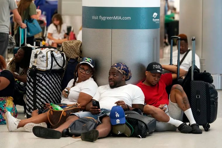 A group waits to check-in their luggage for their flight to Missouri at Miami International Airport on Saturday.