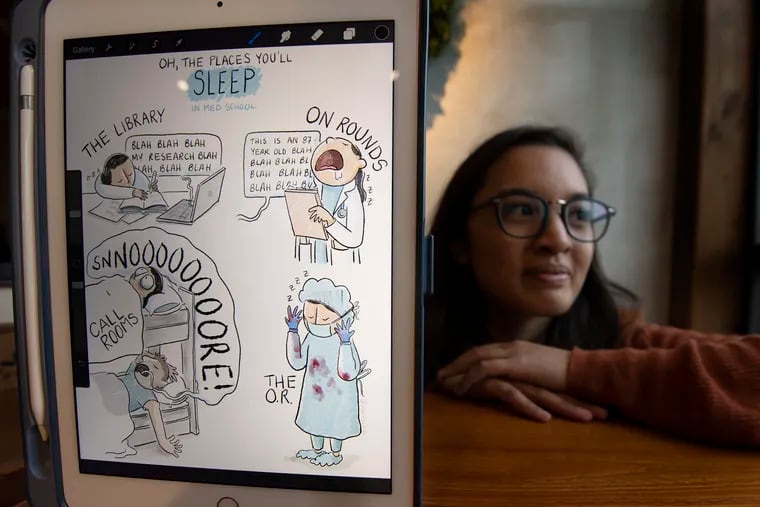 Mai Stewart, a student at Temple University's Katz School of Medicine, shows one of her cartoons about the process of becoming a doctor.