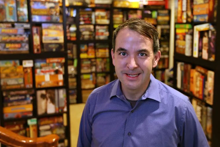 Matt Hendricks, who is opening Thirsty Dice, a board-game cafe, at home in Montgomery County with his massive collection of games.