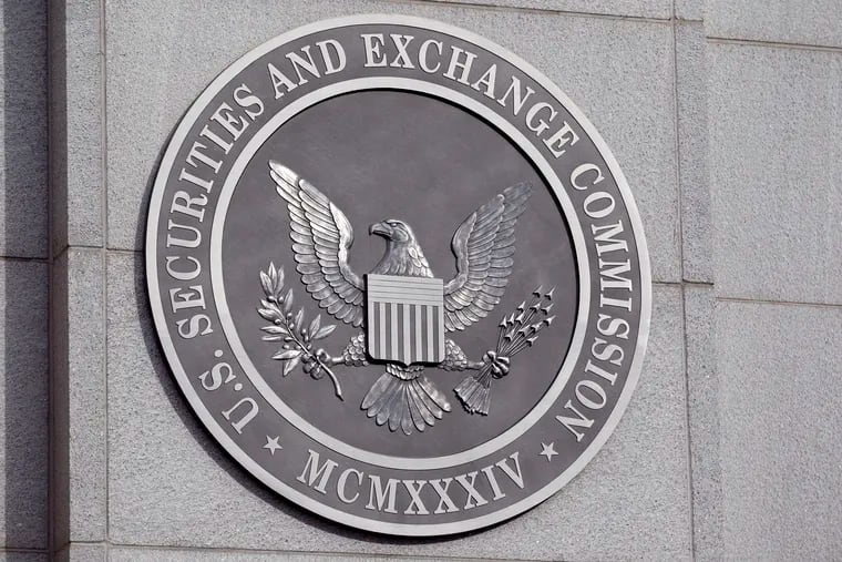 The U.S. Securities and Exchange Commission seal is displayed outside the headquarters in Washington, D.C., U.S., on Wednesday, Oct. 26, 2011. The SEC approved a rule requiring hedge funds and private-equity funds to reveal internal information to U.S. regulators. Photographer: Andrew Harrer/Bloomberg