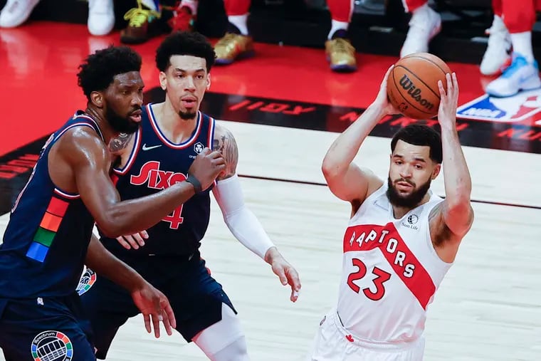 Toronto Raptors guard Fred VanVleet holds the basketball against Sixers center Joel Embiid and forward Danny Green during game four of the first-round Eastern Conference playoffs on Saturday, April 23, 2022 in Toronto.
