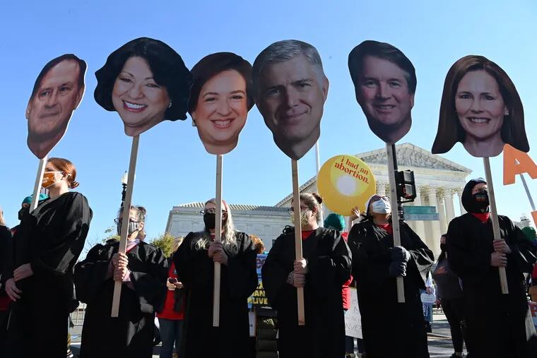 Abortion rights activists carried cutouts of members of the Supreme Court during a Dec. 1, 2021, protest outside the Supreme Court in Washington.