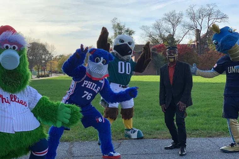 Anthony Murphy, president of the Philadelphia Veterans Parade & Festival, poses with mascots supporting veterans this year amid a pandemic.