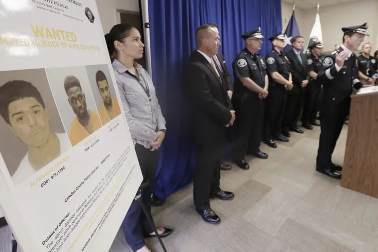At a news conference last month, law enforcement officials and Camden County Police Chief Scott Thomson (right) release photos of the three men charged with the attempted murder of two  Camden County undercover detectives in August.. ELIZABETH ROBERTSON / Staff Photographer