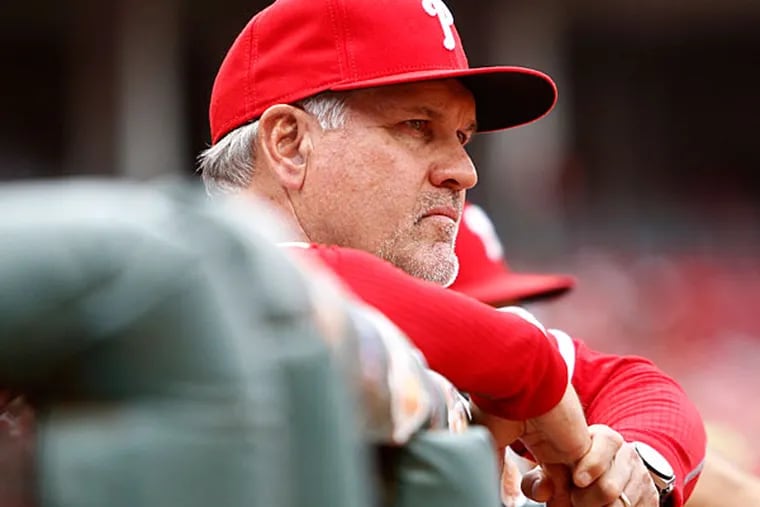 Philadelphia Phillies manager Ryne Sandberg watches from the dugout in the first inning against the Cincinnati Reds at Great American Ball Park. (David Kohl/USA Today)