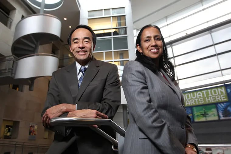 Interim dean Steven Chin left, and Beena Sukumaran, Chair of the Civil Environmental Engineering Department, right, are inside the atrium of Rowan Hall, the engineering building at Rowan University. Rowan University celebrates the 20th anniversary of Henry Rowan's historic $100 million gift, which transformed Glassboro State College into the institution it is today. ( MICHAEL BRYANT / Staff Photographer )