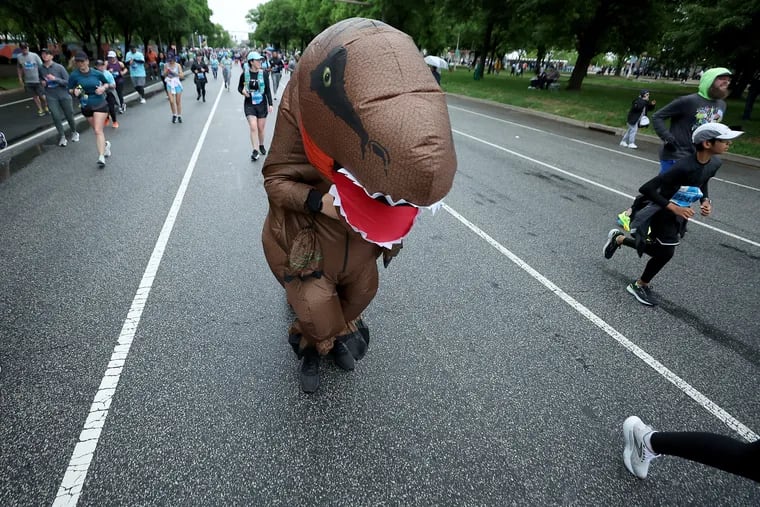 Bill Searles, of Laurel Springs, N.J., wears a dinosaur costume as he runs the race. When asked if he wore it for the entire race, he replied, “I’m not crazy. Just the last four miles."