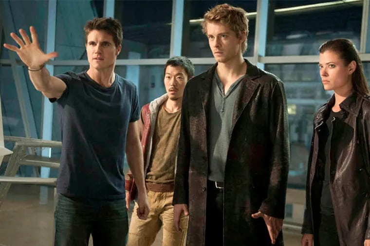 &quot;The Tomorrow People,&quot; which premieres Wednesday on the CW, stars (from left) Robbie Amell as Stephen, Aaron Woo as Russell, Luke Mitchell as John, and Peyton List as Cara. (Barbara Nitke / The CW)