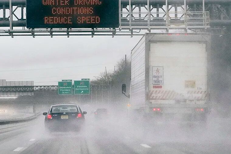 Road signs warn drivers about bad conditions  northbound on Rt 295 in Gloucester County on November 26, 2014.  ( ELIZABETH ROBERTSON / Staff Photographer )