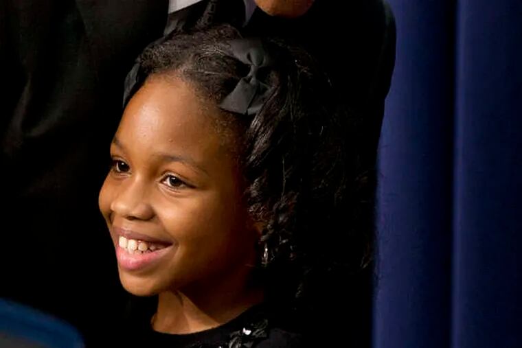 President Obama hugs Alajah Lane, 9, of Washington, after she introduced him Wednesday at the White House, where he spoke about early childhood education.