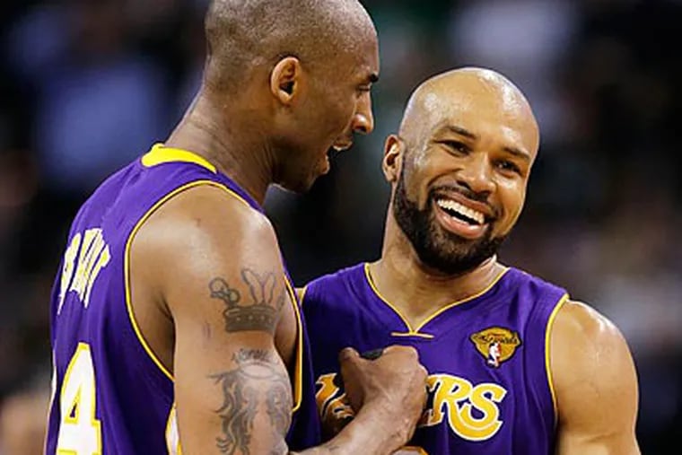 Kobe Bryant and Derek Fisher celebrate in the closing moments of the Lakers' win. (Michael Dwyer/AP)