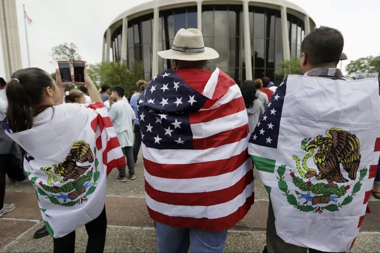 In this June 26, 2017, file photo, protesters outside the federal courthouse in San Antonio, Texas, take part in a rally to oppose a new Texas sanctuary cities bill that aligns with the president's tougher stance on illegal immigration.