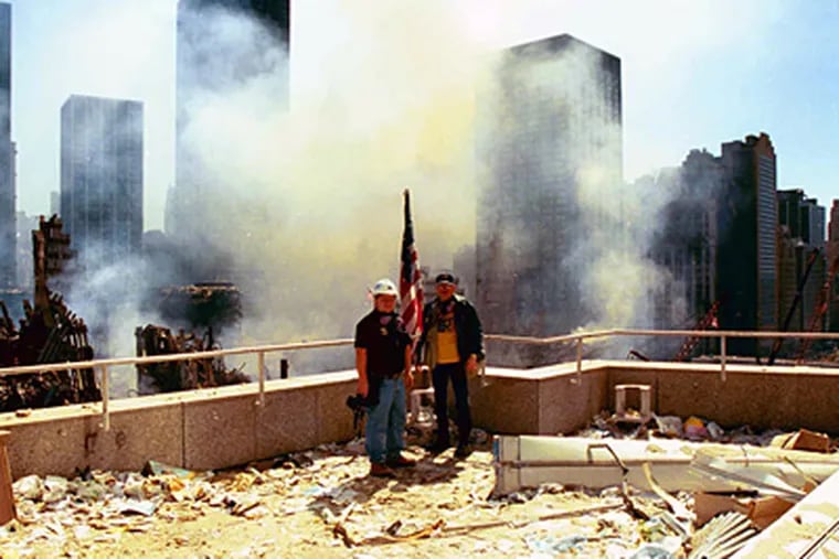 John Taggart and Michael Vincent, two members of the crime scene investigative team that the Philadelphia Police Department sent to ground zero, examine a rooftop at the disaster site. (Photo Courtesy Michael Vincent)