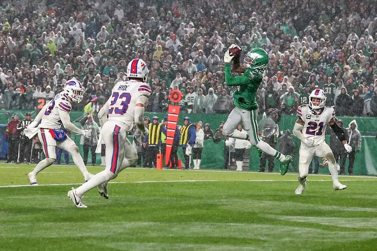Eagles wide receiver DeVonta Smith (center) finished with 81 catches for 1,066 yards and seven touchdowns, including this one against the Buffalo Bills. It was his second straight 1,000-yard season.
