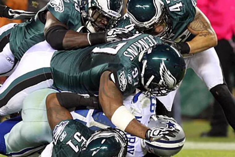 DeMarco Murray is crushed by a horde of Eagles defenders. (Yong Kim/Staff Photographer)