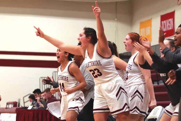 Swarthmore College Women's Basketball players celebrate on the bench on Nov. 20, 2019 during their game against Widener College. L-R: Isabelle Ewart, #14; Erin Cronin, #23; and Karinna Papke.